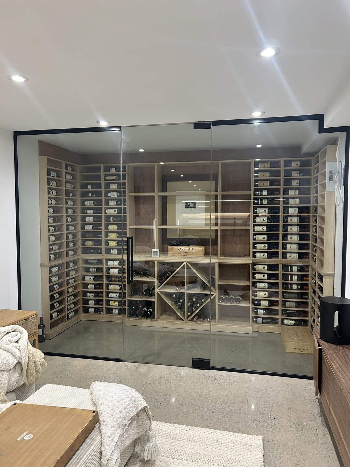 Glass wine cellar with wooden racks