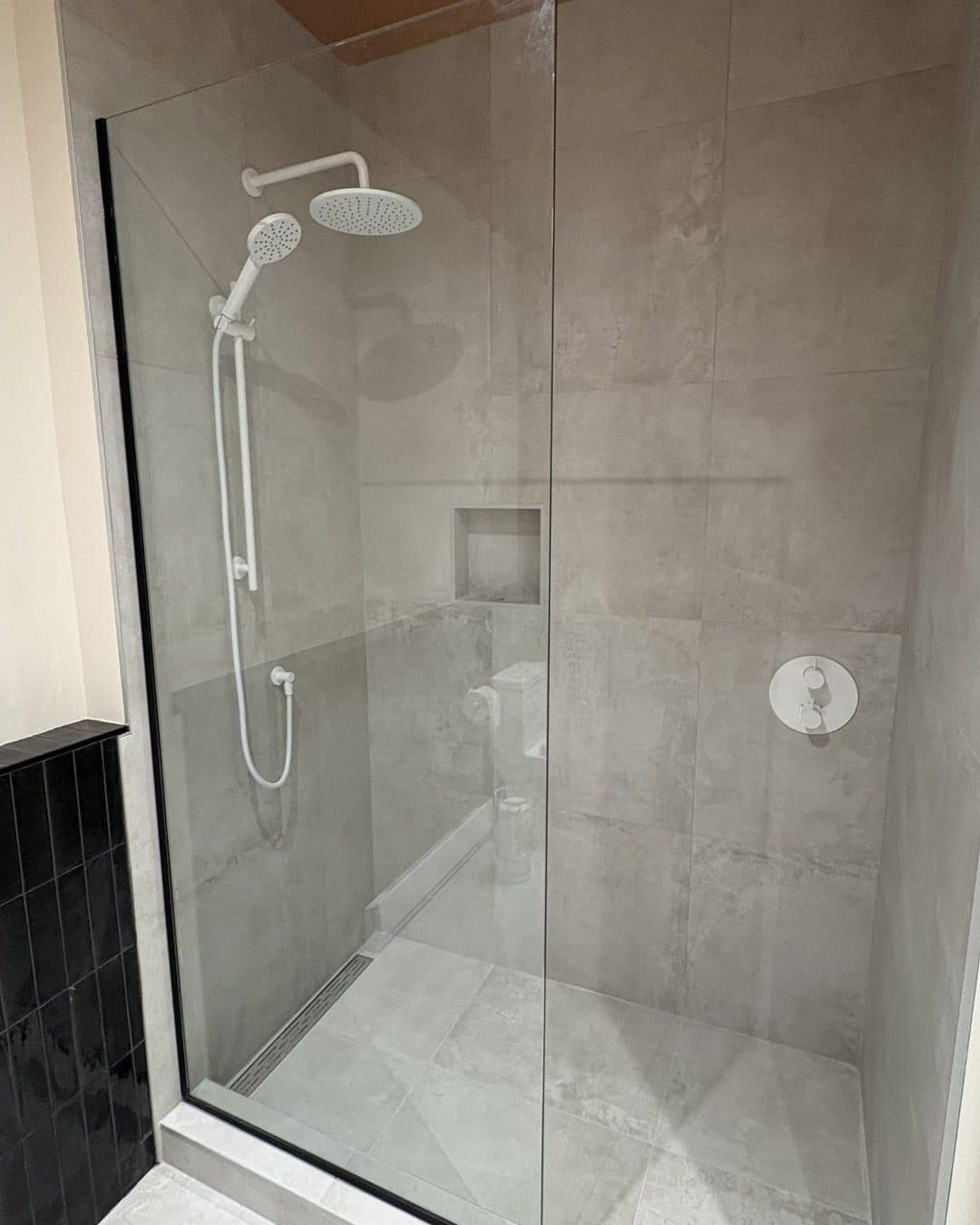 Clear glass shower in a grey bathroom