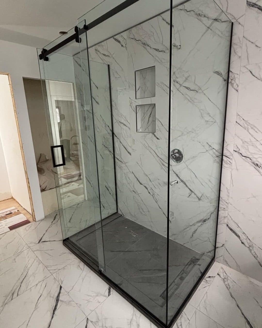 Tempered glass corner shower with marble-look tile