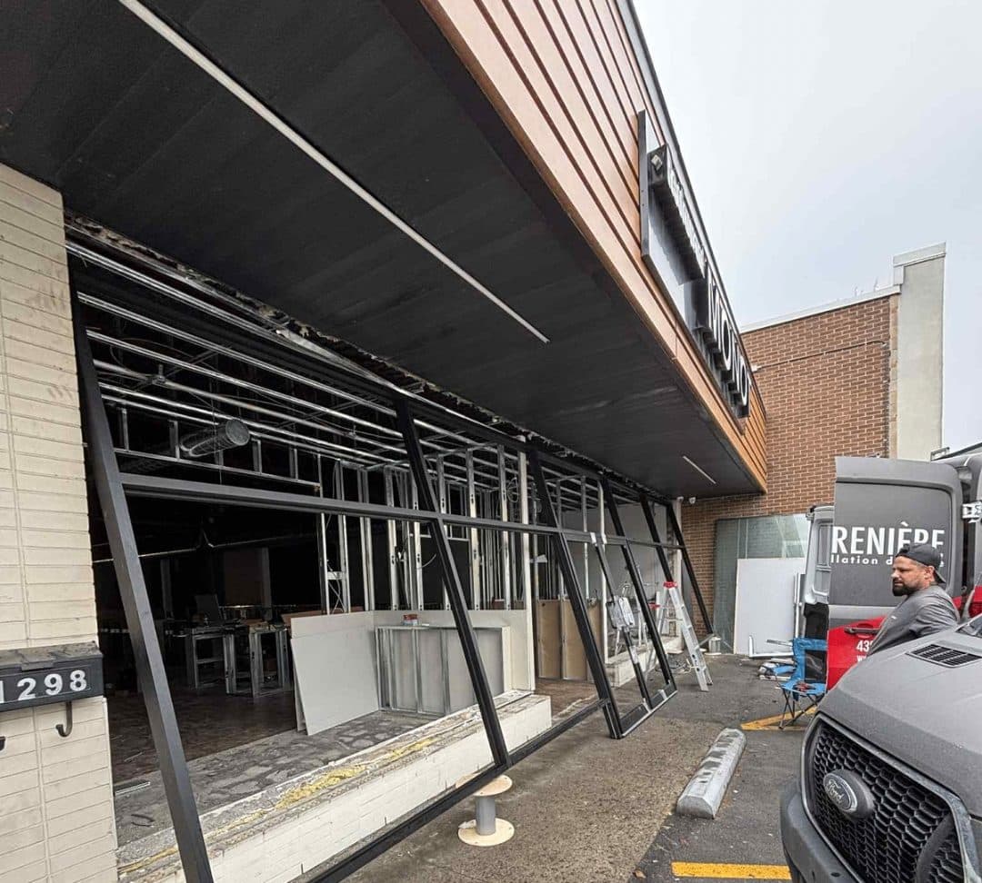 Storefront glass being installed on a facade